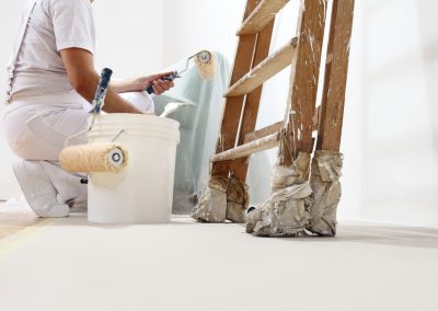 painter man at work with a roller, bucket and scale, bottom view